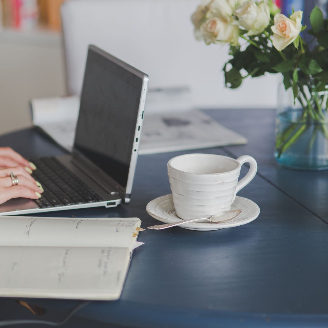 Närbild på laptop och kaffekopp