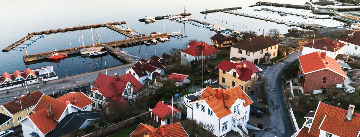 Villaområde vid havet med hamn i bakgrunden