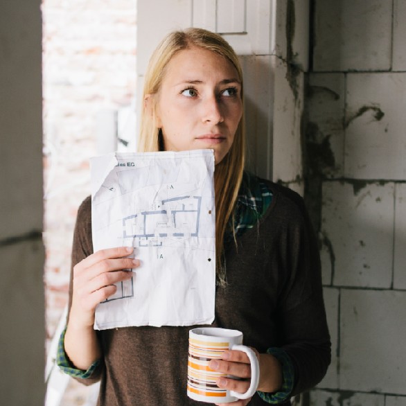 Kvinna i villa med slitna väggar