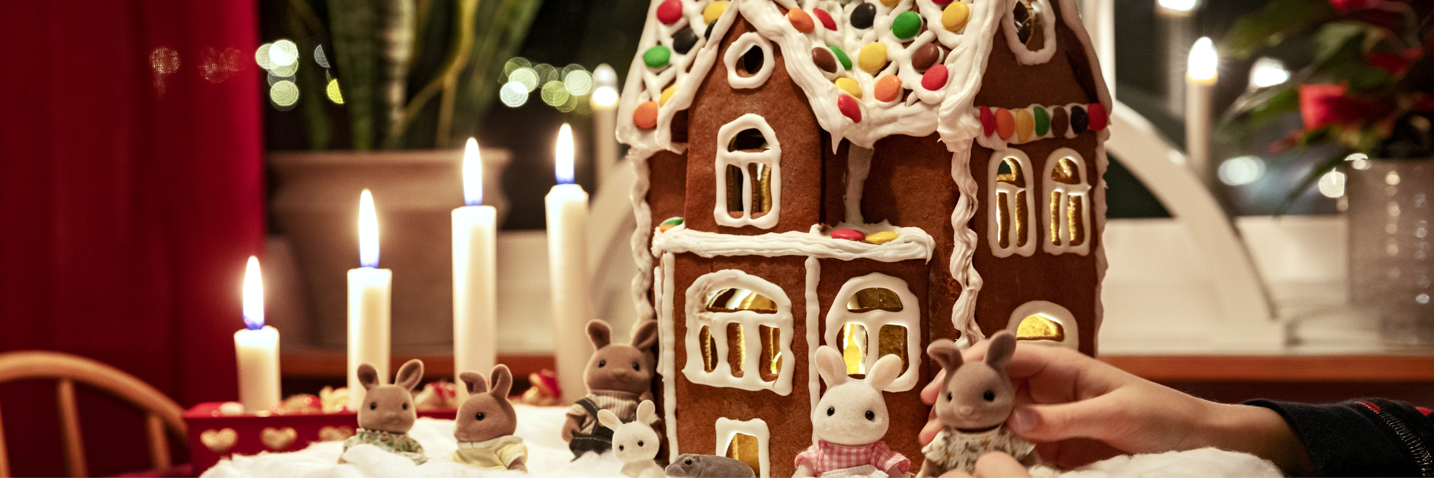 Adventsljus och pepparkakshus på ett bord